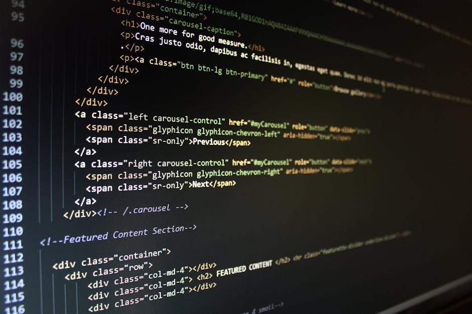 A close-up view of a laptop screen displaying lines of computer code related to software development, with a dark background and illuminated keys. The code features syntax highlighting in various colo